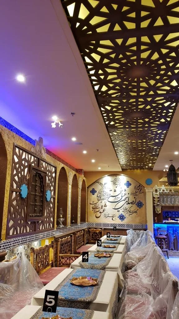 Restaurant seating beneath decorative ceiling panels