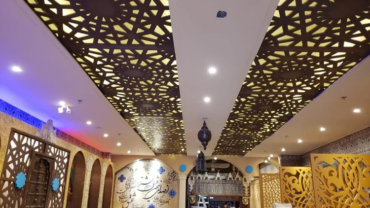 Patterned ceiling panels above a restaurant interior