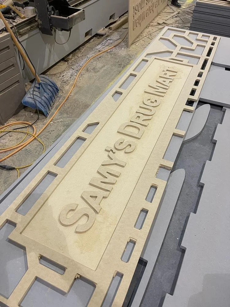 Cut lettering and an ornamental panel on a work surface