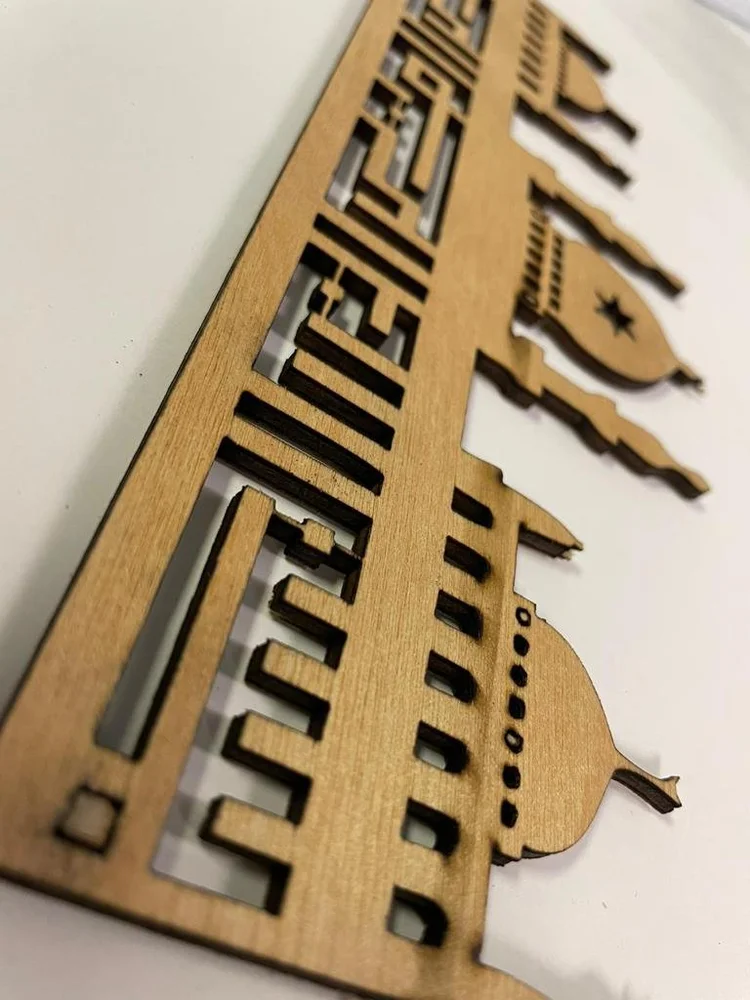 Wood lettering and decorative pieces laid out in a workshop