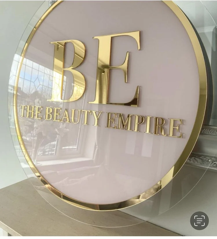 Circular business sign with raised lettering