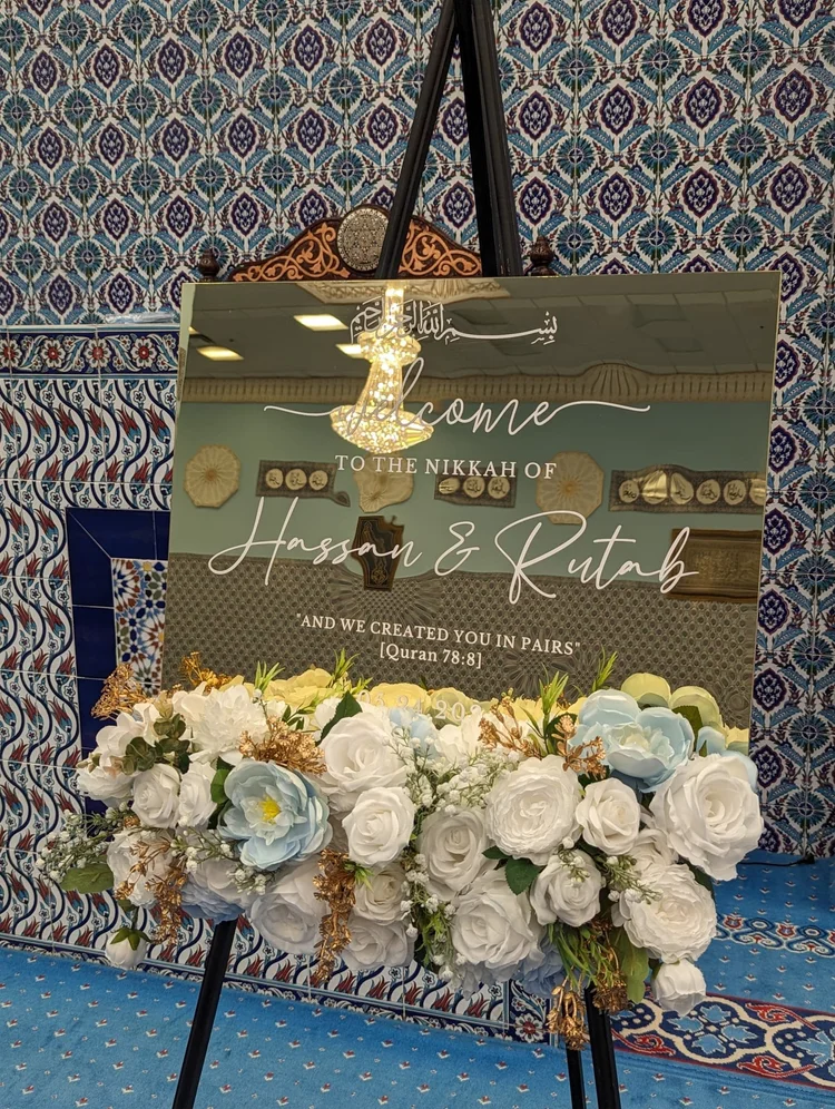Personalized sign displayed among flowers