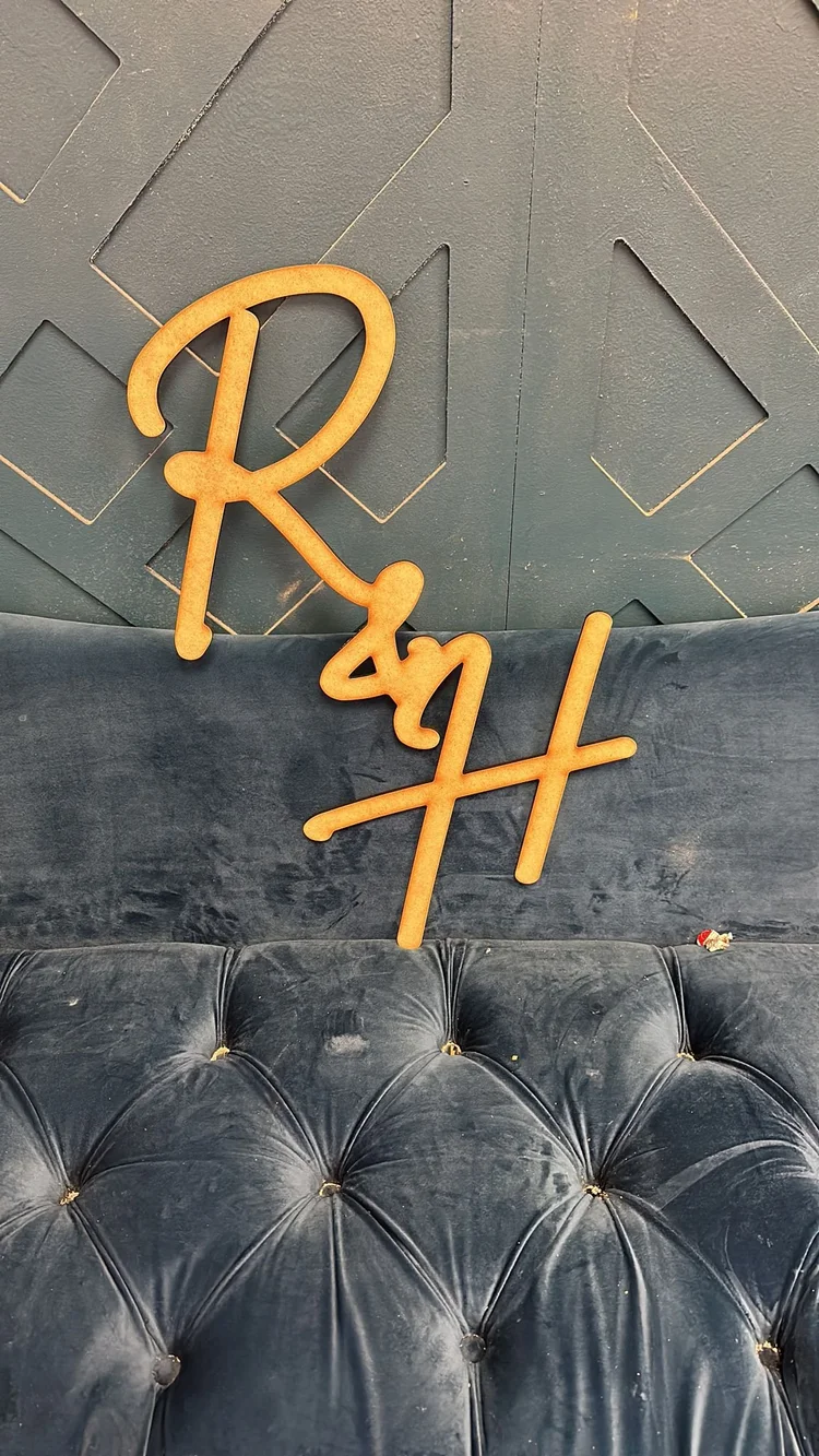 Gold dimensional lettering on a dark upholstered backdrop