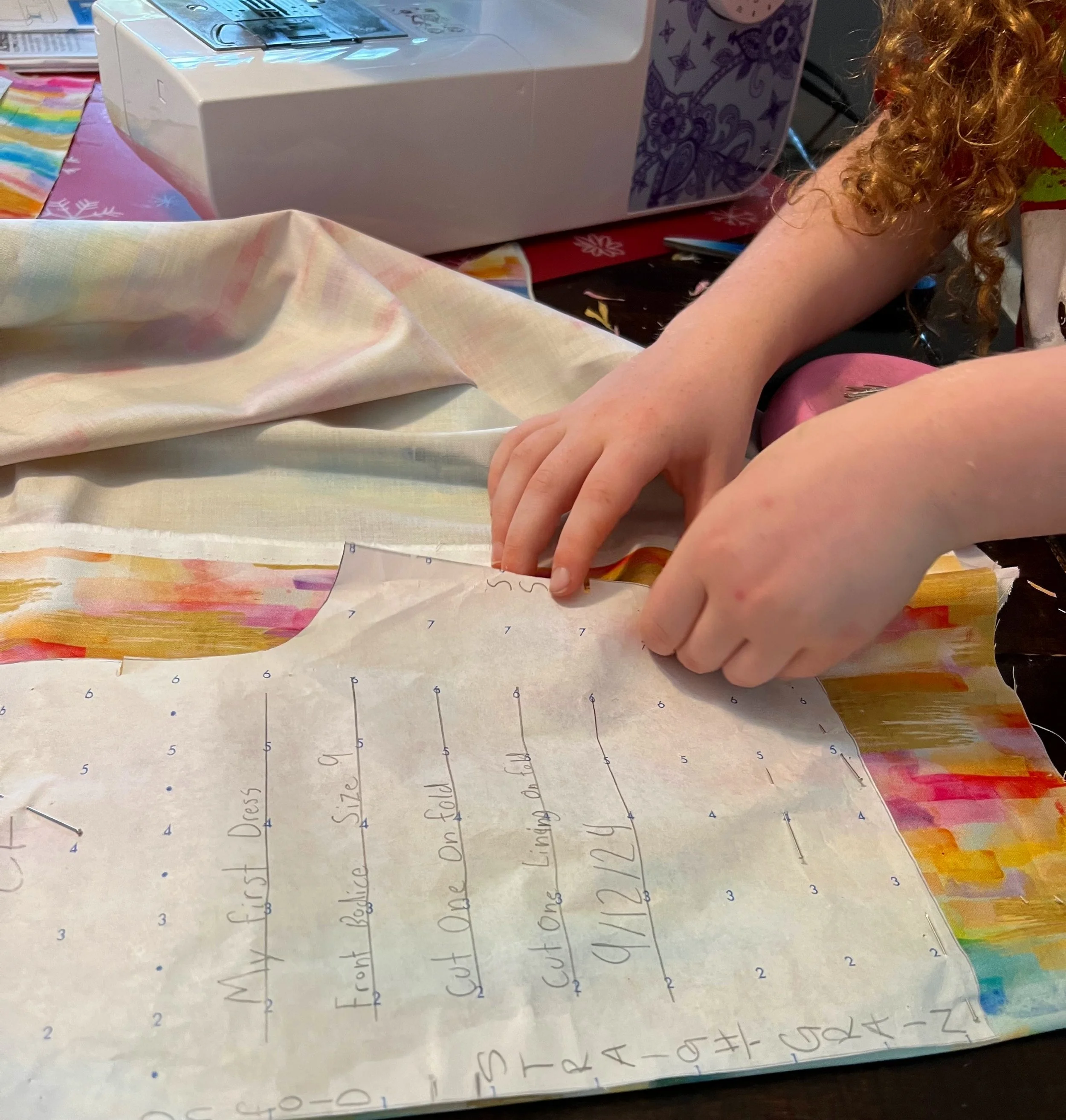 diy girl working on a pattern for a multicolored dress