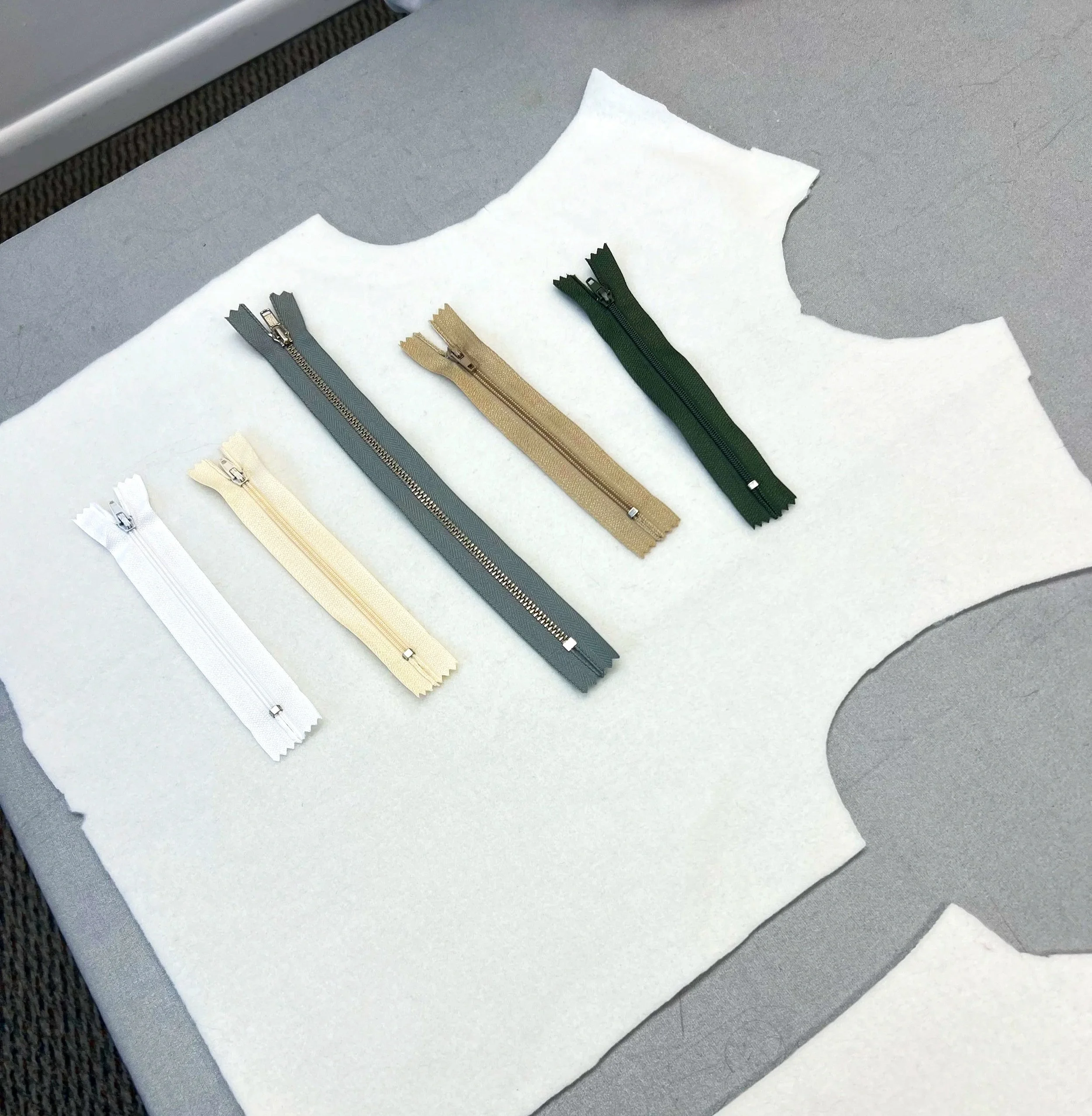 White T-shirt top with unfinished zippers placed on top