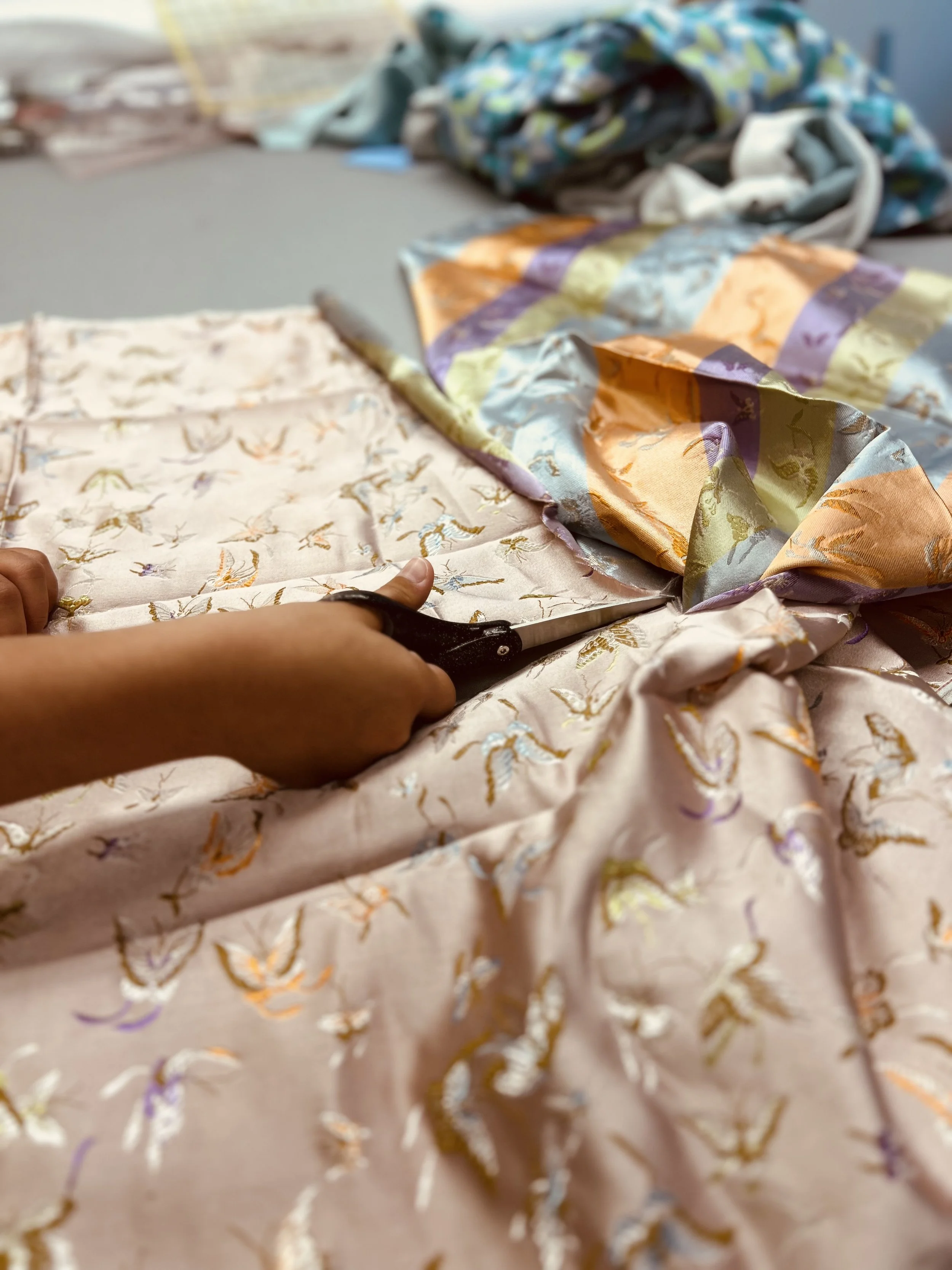 cutting chinese damask satin in peach and gold colors
