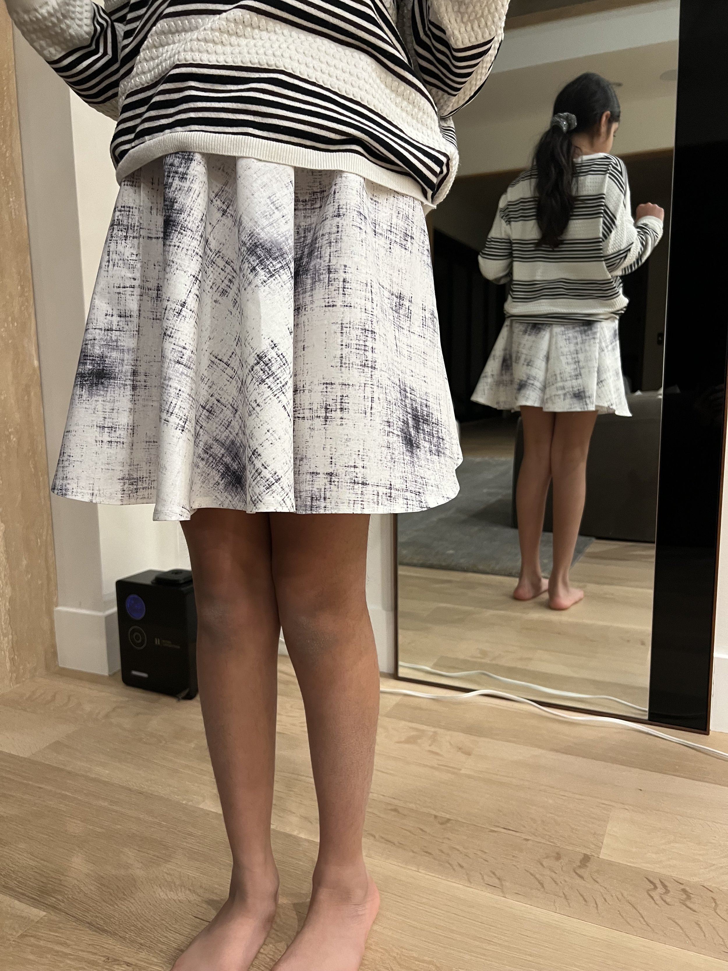 black and white circle skirt and mirror image of girl, in Short Hills, NJ