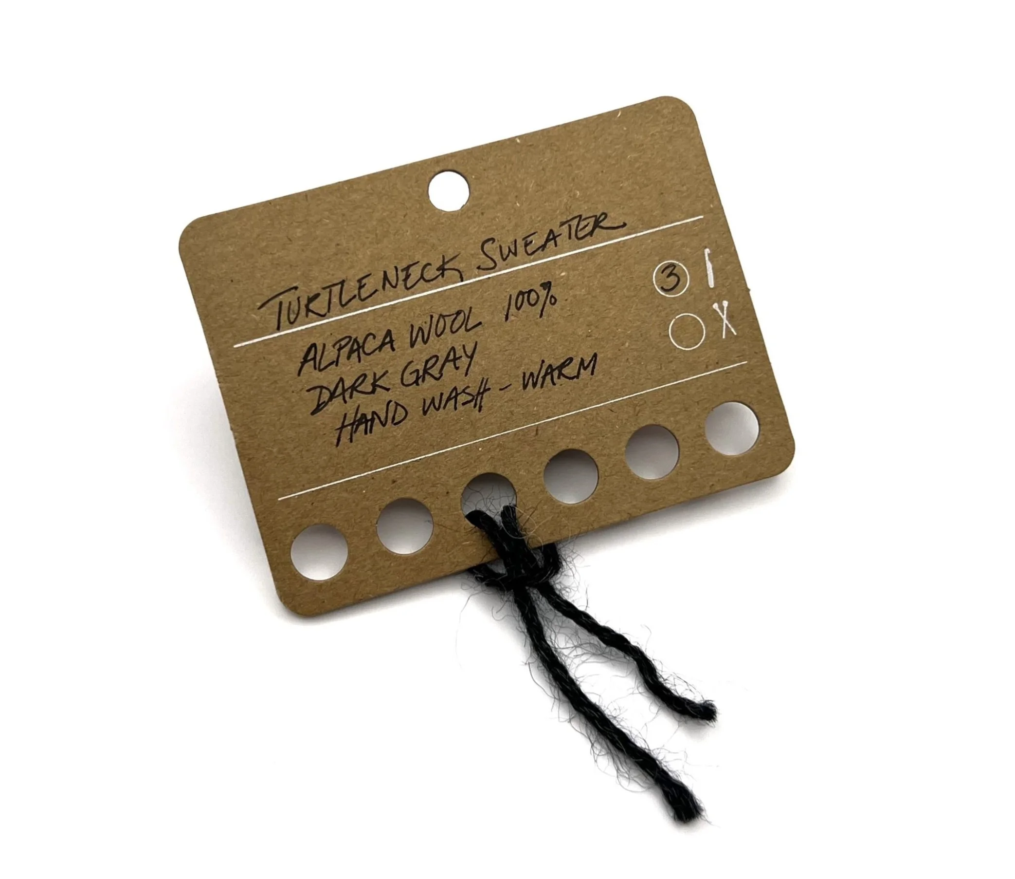 brown swatch card for yarn with description for type and wash