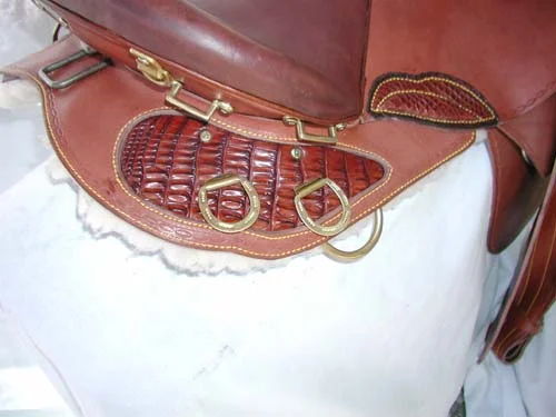 Crocodile skin has been added to the back skirting of this saddle, along with crocodile skin for the thigh patch. Cost of this, as you see it, on both sides of the saddle, is $600