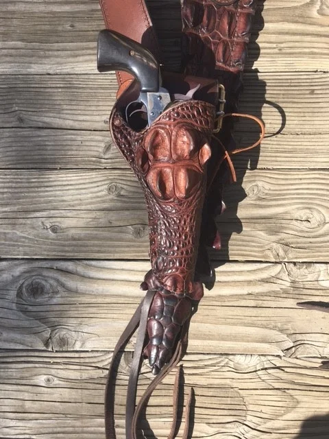 ABOVE, A CROCODILE LINED HOLSTER, WITH HEAD, THIS FOR A 7 1/2" PISTOL. COST OF THIS HOLSTER IS $495