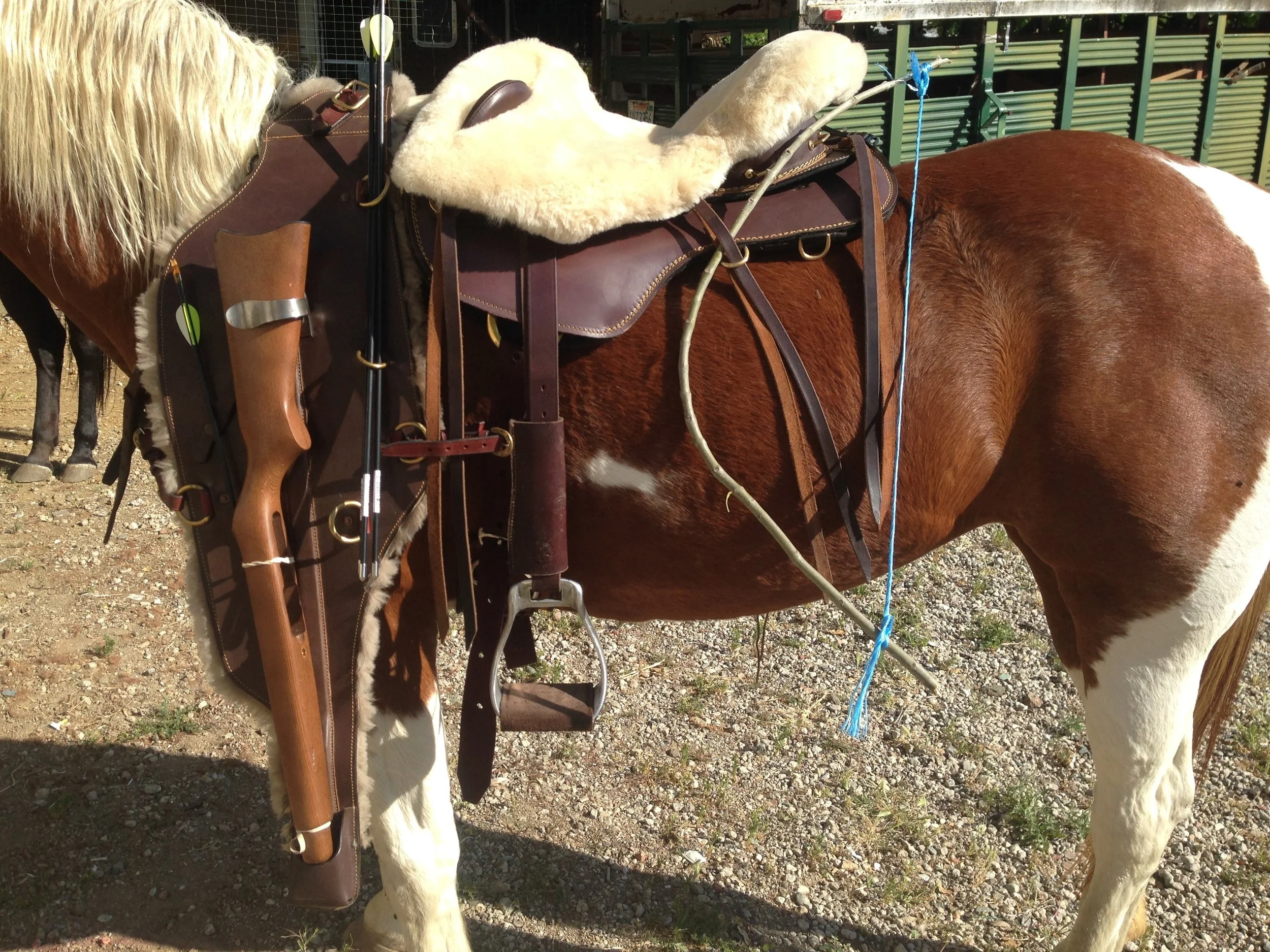 THE LEATHER BAREBACK SADDLE SHOWN WITH MOCK UP RIFLE IN A FORWARD CARRYING PACK, WITH ARROWS AND A SHORT MOCK UP BOW SECURED TO THE BACK. Call Colin 818 309-8125 and give him instructions as to what you would like to carry, kind of rifle, length of bow, etc, and he will customize the rig as needed .THE OFFSIDE OF THIS RIG HAS A HEAVY SADDLE BAG TO BALANCE THE EQUIPMENT WITH EQUAL WEIGHT ON EITHER SIDE,. 