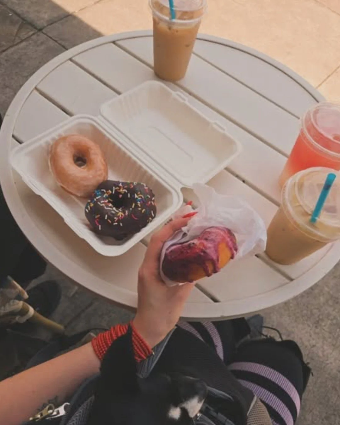 Thanks to @cicada.cellar for sharing this sweet moment with us! 🤍 Nothing makes us happier than seeing you soaking up the sunshine at our cafe sidewalk tables with vegan donuts, iced lattes, and good company (especially pups 🐶).

Stop by today and 