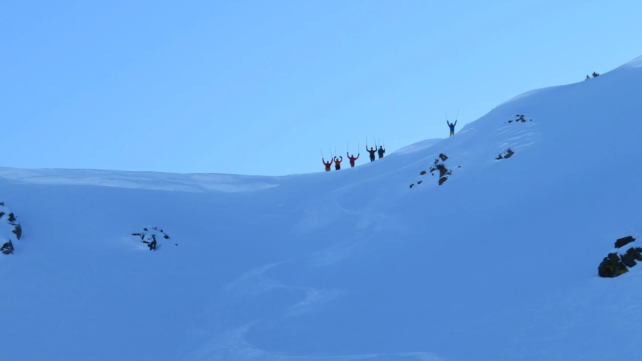 Skiers on backcountry ridgeline