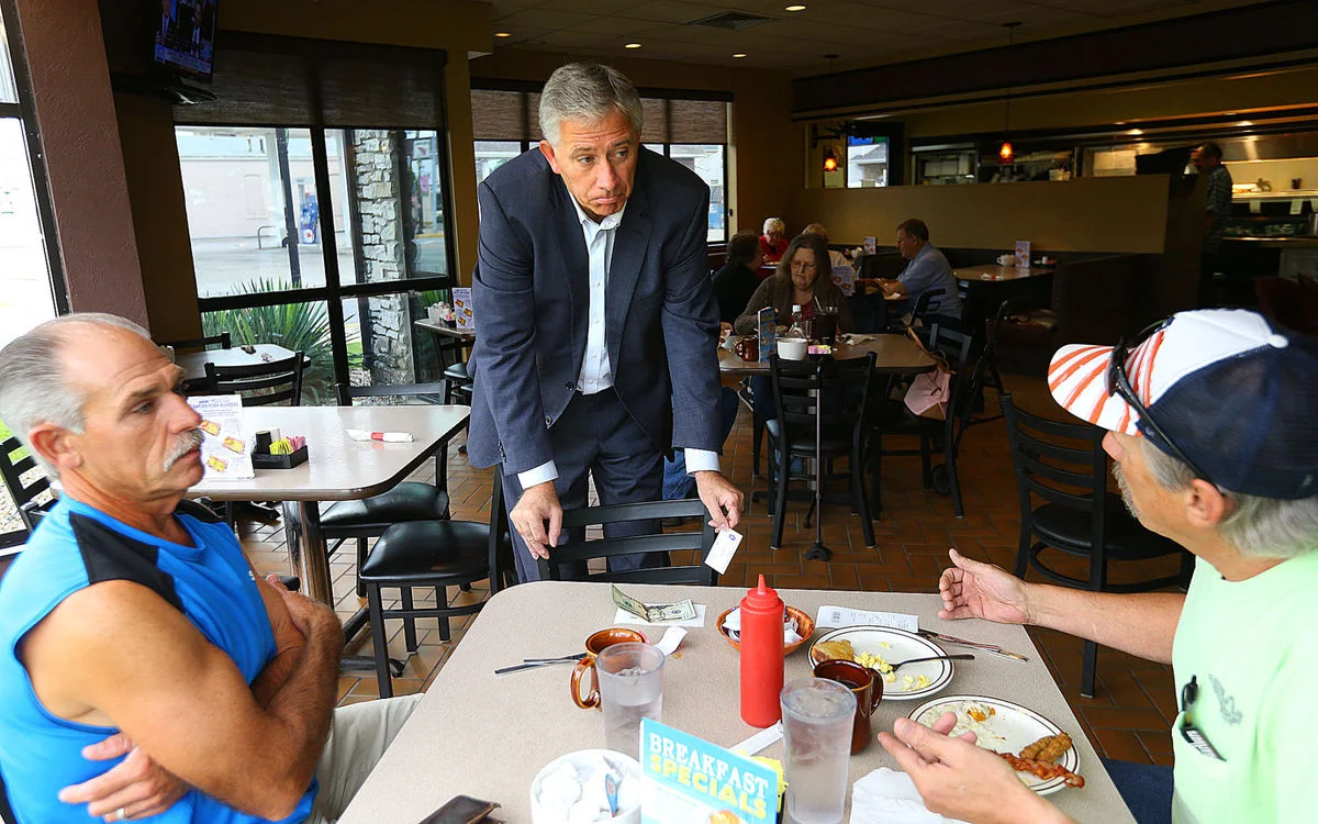 CANDIDATE: Kokomo attorney Mark Hurt stops to talk to customers like Dave and Dan Newman while on the Senate campaign trail at the Jim Dandy in Tipton on Friday.