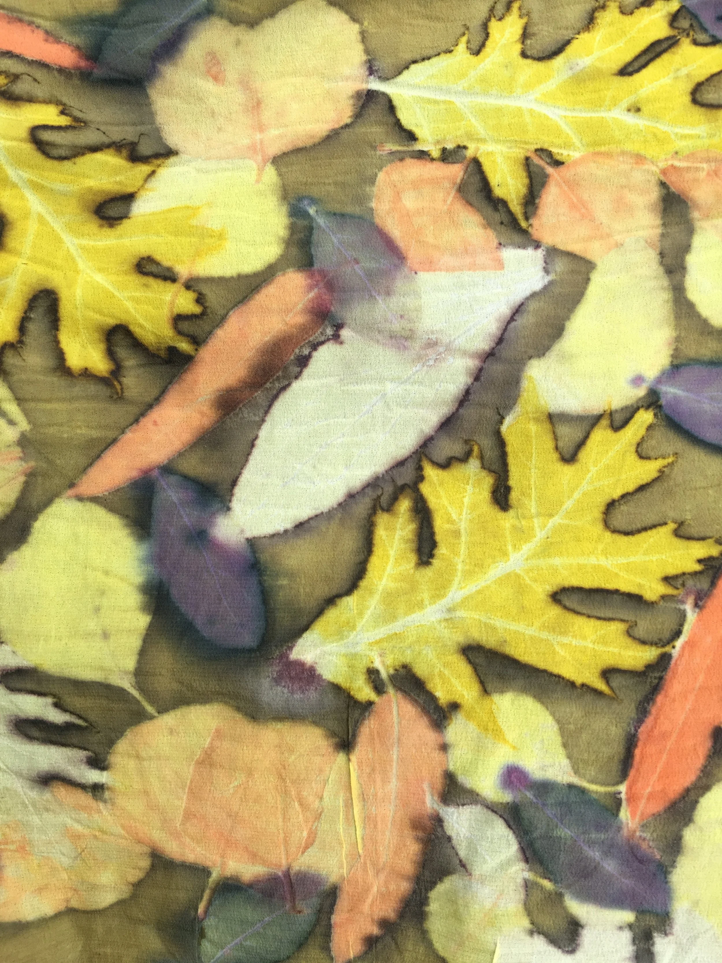 Detail of a silk scarf dyed with Weld and printed with Oak, Eucalyptus, Peony, and Prunus leaves.