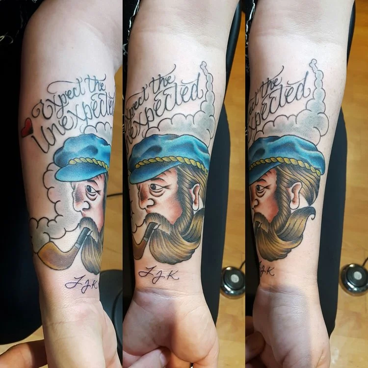 Sailor Captain with beard smoking a pipe in color. Forearm half sleeve tattoo. 