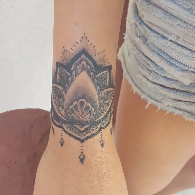 Lotus Mandala black and gray with stippling. Forearm and wrist tattoo