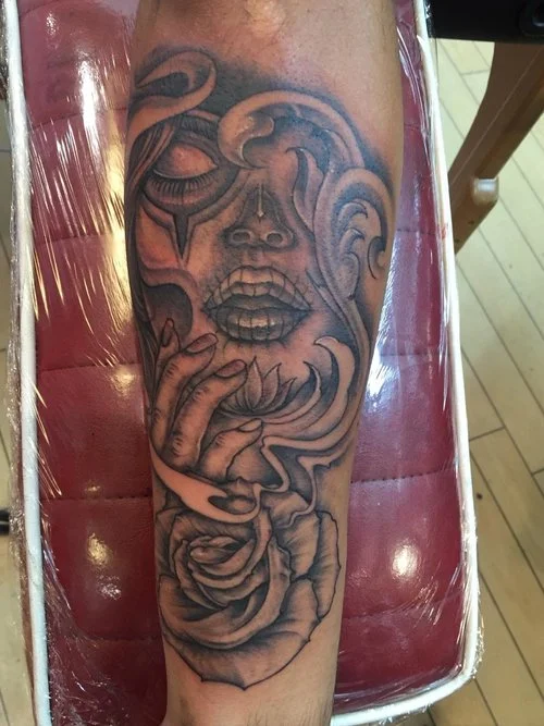 Day of the dead skull pinup and rose in fine detail black and gray.