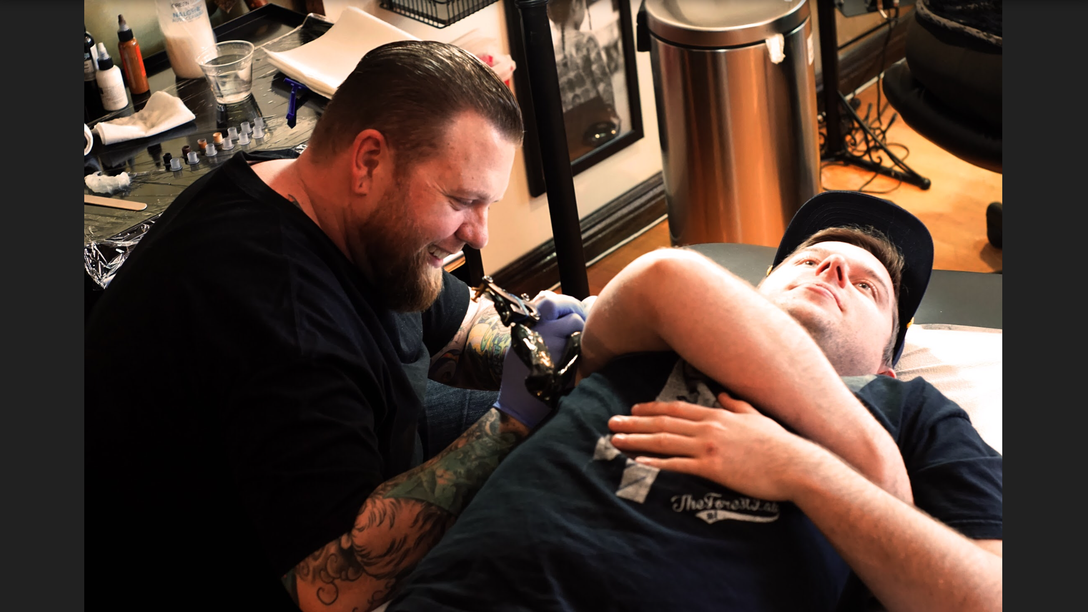 Weezy at work on an upper arm sleeve tattoo. 