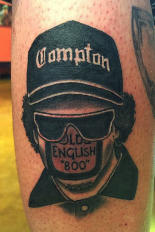 Eazy-E portrait black and gray. Compton NWA theme half sleeve leg tattoo. 