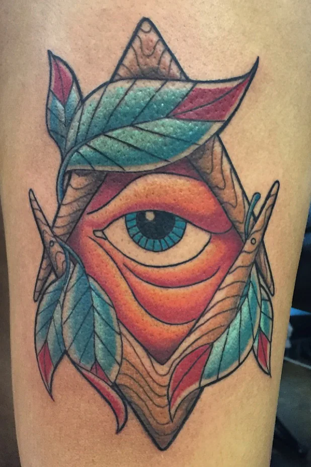 Eye of Providence, Masonic's the All seeing eye with feathers. Lower thigh color tattoo