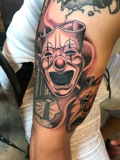 Theater Masks "Happy" black and gray fine detail. Upper arm Half Sleeve Tattoo.
