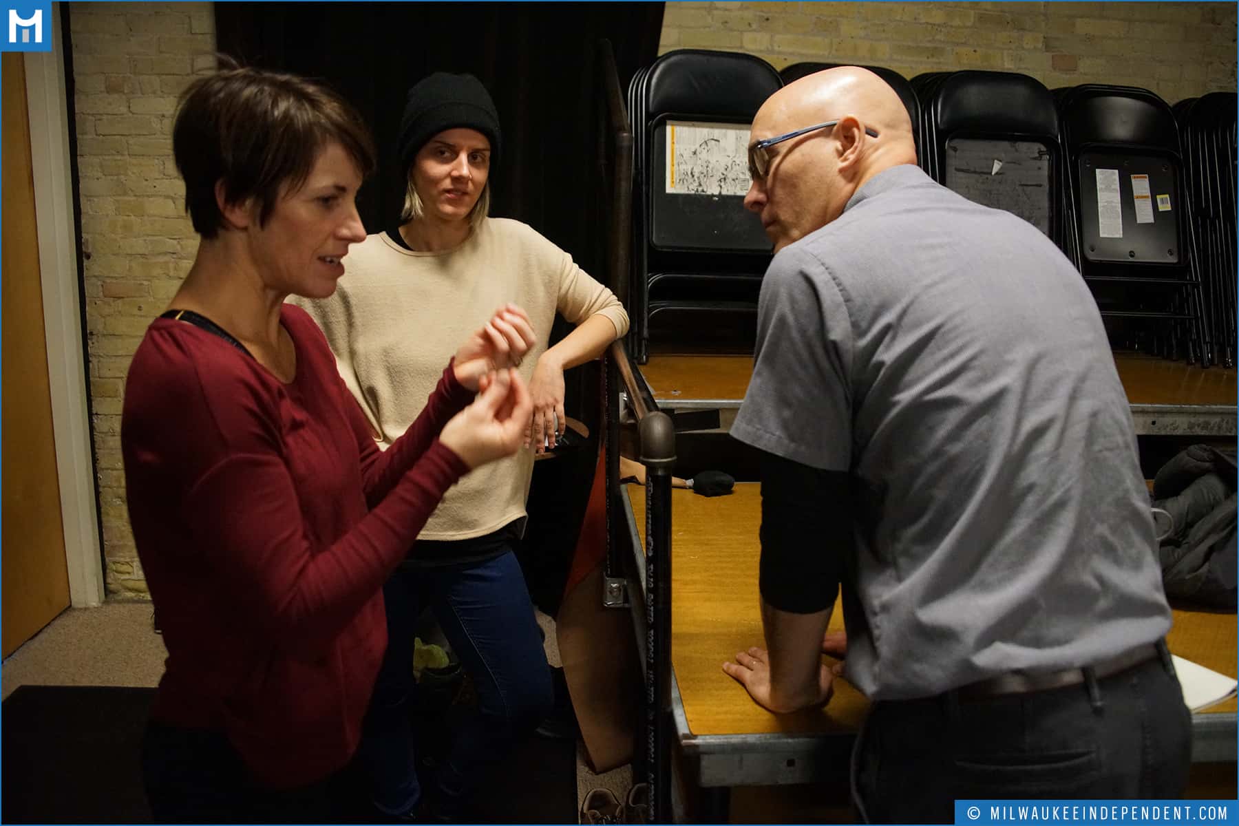  Dani Kuepper (choreographer and Danceworks Artistic Director), a light-skinned woman wearing a maroon sweater,  Kym McDaniel (film),  a light-skinned woman wearing a beige sweater and black beanie, and Edward Morgan (writer and director), a light-sk