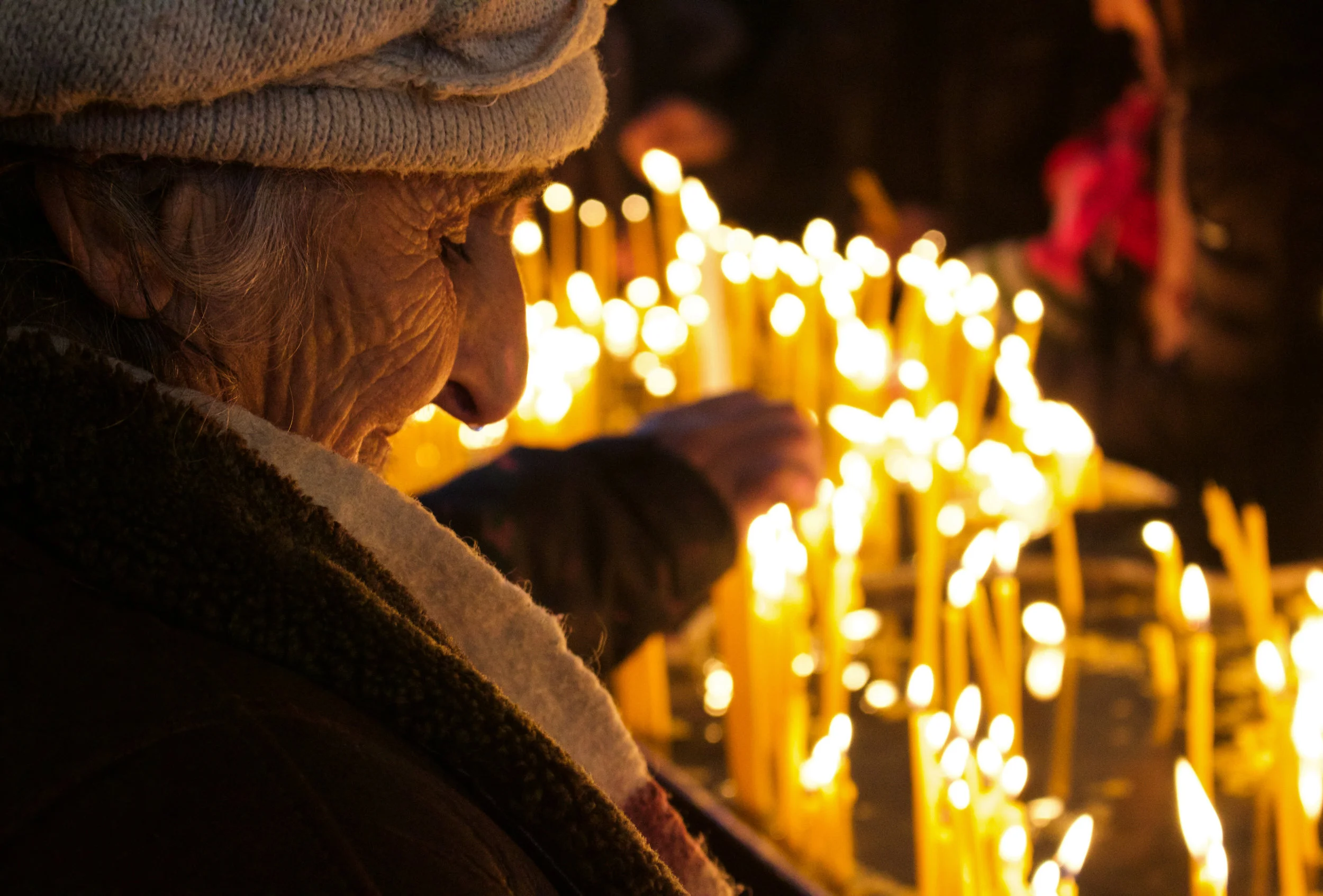 A woman comes in from the cold and smiles as she lights a candle in Etchmiadzin on January 6th, when Armenians observe Astvats e Haytnutyun , "the appearance of God among men" - a celebration of the nativity and baptism of Christ. Around 340 AD, the Roman Empire's church hierarchy changed the date to December 25th to replace a pagan festival that did not exist in Armenia. Adopting the practice was irrelevant to Armenians and they chose to remain loyal to the ancient custom, celebrating the feast on this day for the last 17 centuries.