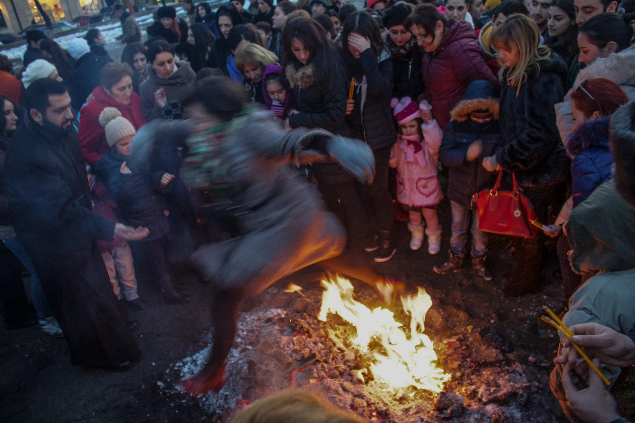Trndez, or Tyarndarach, is pagan in origin and is originally connected with Sun/Fire worship in ancient pre-Christian Armenia, symbolizing the coming of spring and fertility. The holiday was meant to strengthen the heat of the sun, influencing cold with the help of fire. The fire symbolized the birth of Vahagn, and the young women jumping over it were said to have done so in order to bear strong and intelligent children - a dedication to Mihr and Tir, the gods of fire and knowledge. Jumping over the fire was also said to have a purifying power to help fight disease and bad luck. In the church it is now celebrated as a feast of purification celebrated 40 days after Jesus birth. This was photograph was taken in the courtyard of Saint Gregory the Illuminator Cathedral in the center of Yerevan, the largest Armenian cathedral in the world.