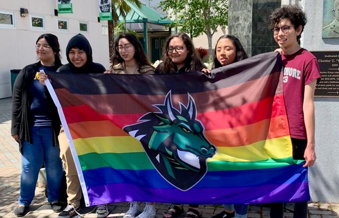 Participants in a youth leadership team show off the Pride flag they were able to fly at Sonoma Valley High School that includes the campus' dragon mascot. Holding up the flag, from left to right, are Maria Ramirez, Axel Sagrero, Itzel Montes, Maggi…