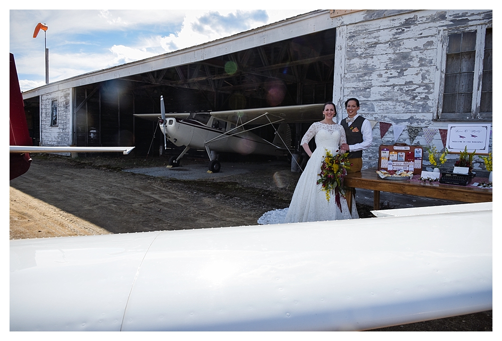 Amelia Earhart Vintage Hangar Wedding Welcome Table Two Brides.jpg