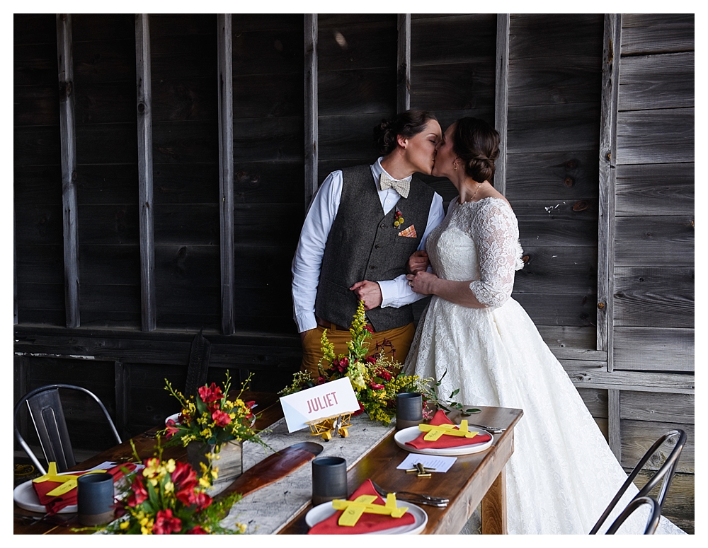 Amelia Earhart Vintage Hangar Wedding Two Brides  Candid Kiss Table Setting .jpg