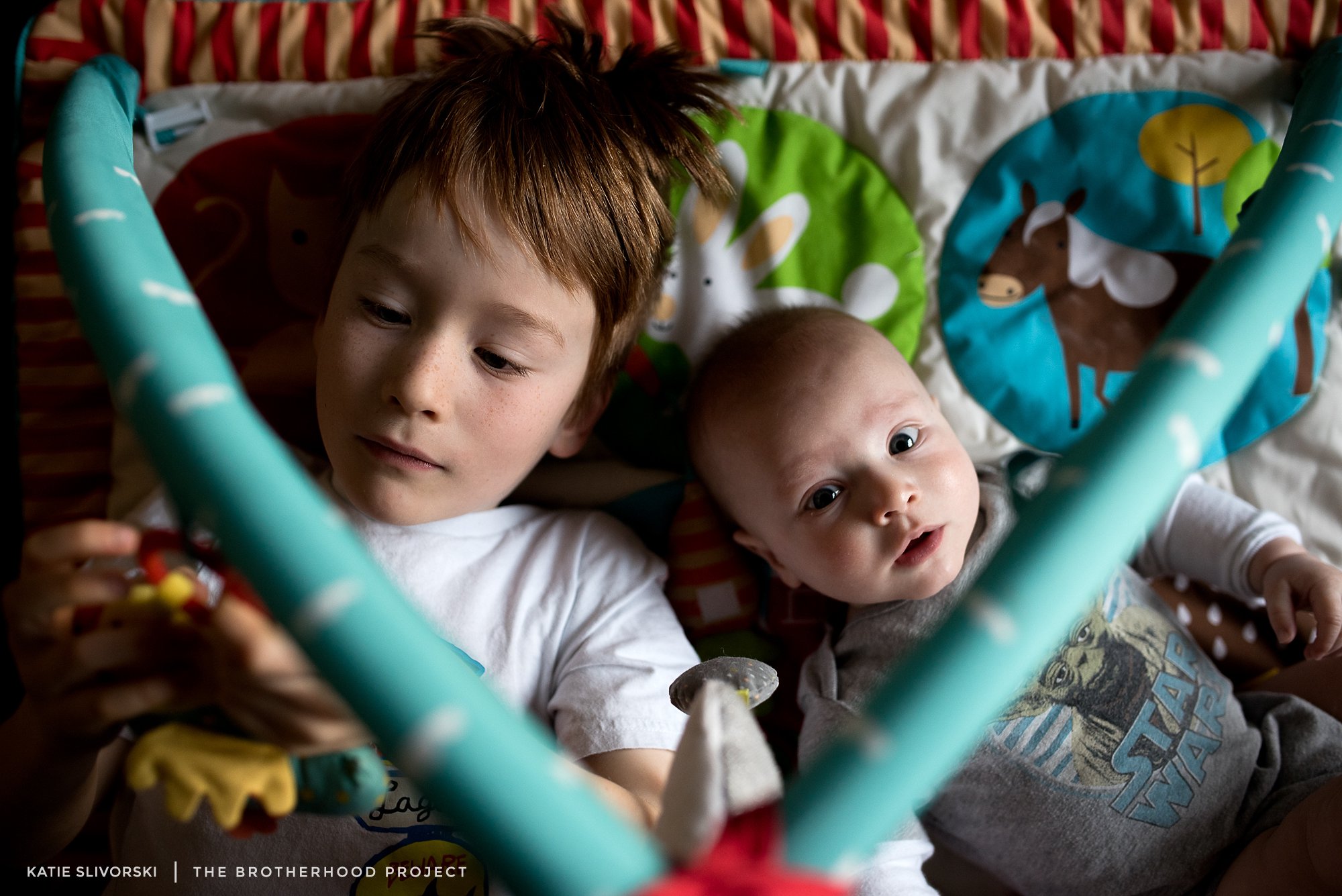 You really don't play together yet, in the typical sense. Bright colored baby toys seem to have universal appeal though, and the little play gym seems to be everyone's favorite.