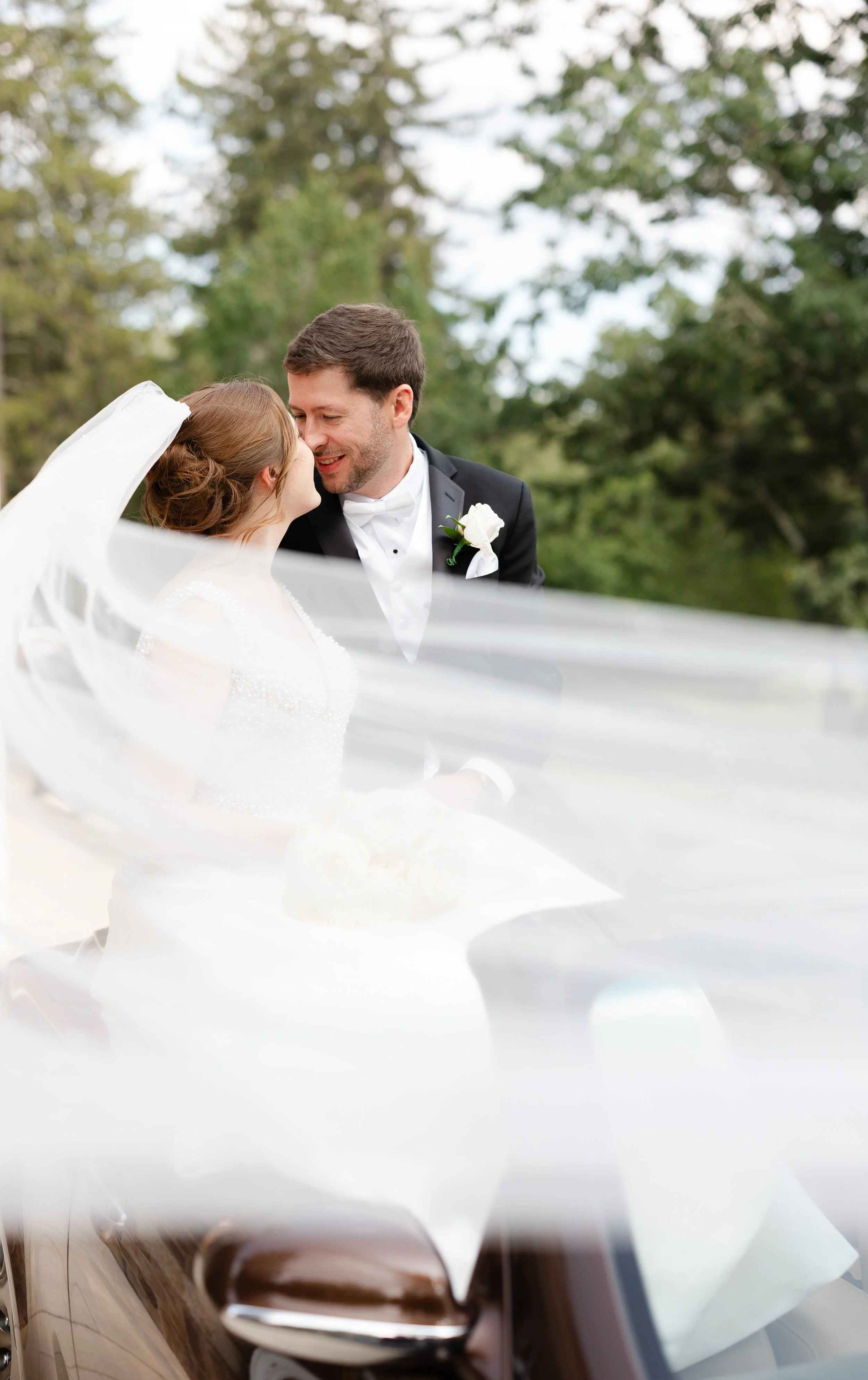 Bride and Groom kissing on car in New Hope PA