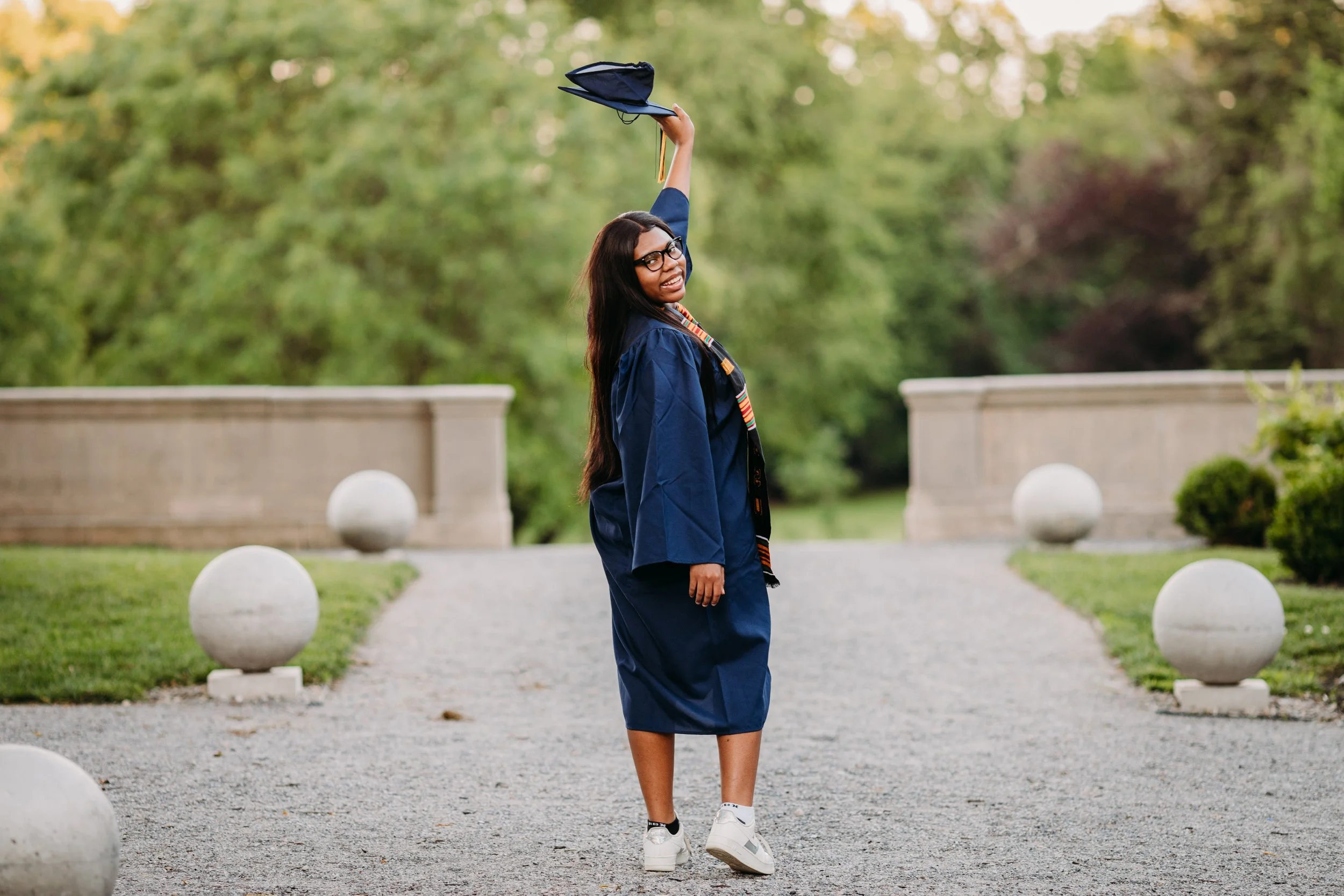 a student with a cap and gown celebrating their senior photos in Bucks County PA