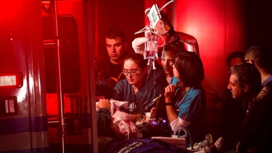 A critical patient from NYU Langone is loaded into a CPMU ambulance