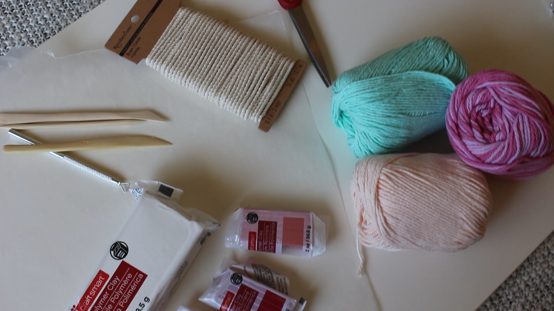 Supplies: polymer clay (pink, red, white), yarn, thin rope