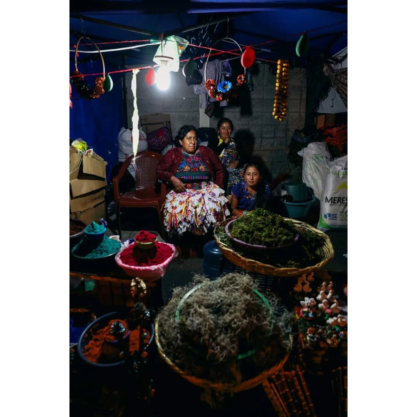 Merry Christmas from Guatemala. May your peace and love be felt deep, I truly wish this for you. 
.
1. A mother gathers her children for a family picture at the Christmas market. 
2. A woman keeps the fire going with her bare hands.
3. A young girl w