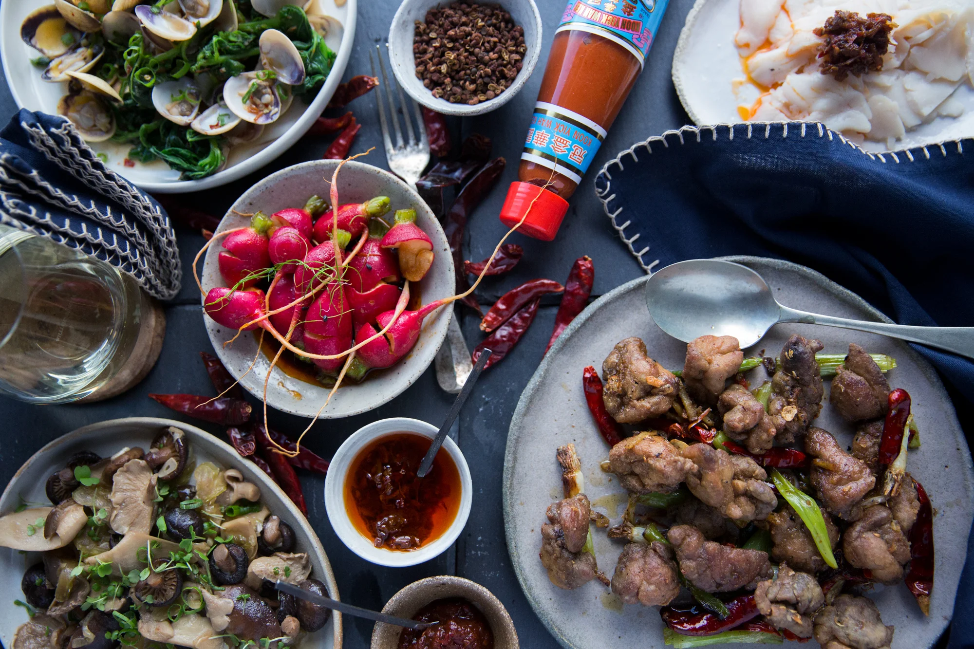 Salt and pepper sweetbreads, radishes with chilli oil, stir fried mushrooms with cuttlefish, clams with samphire and XO.&nbsp;
