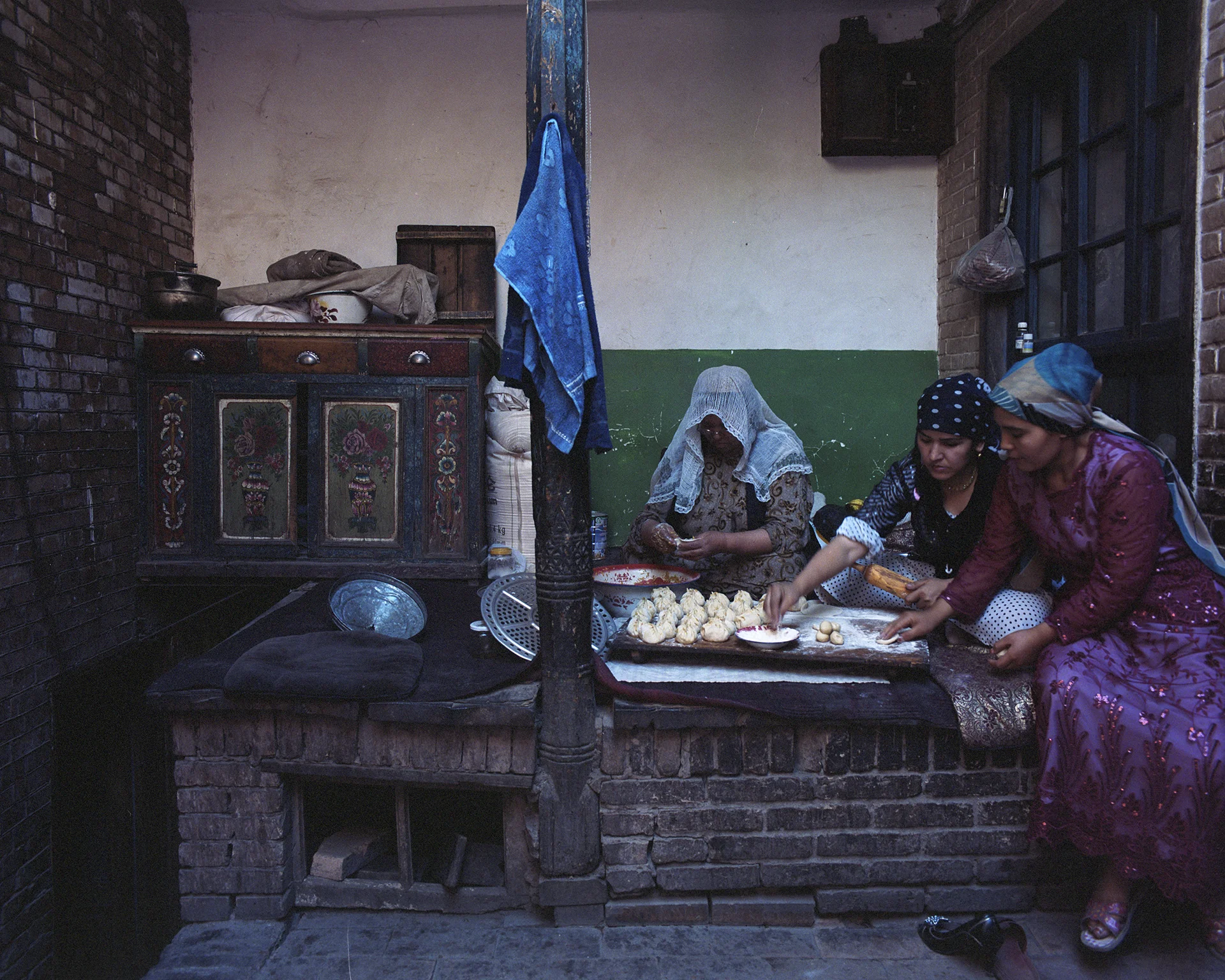 2007 Xinjiang - Women preparing lunch in their small patio in the old centre of Kashgar.