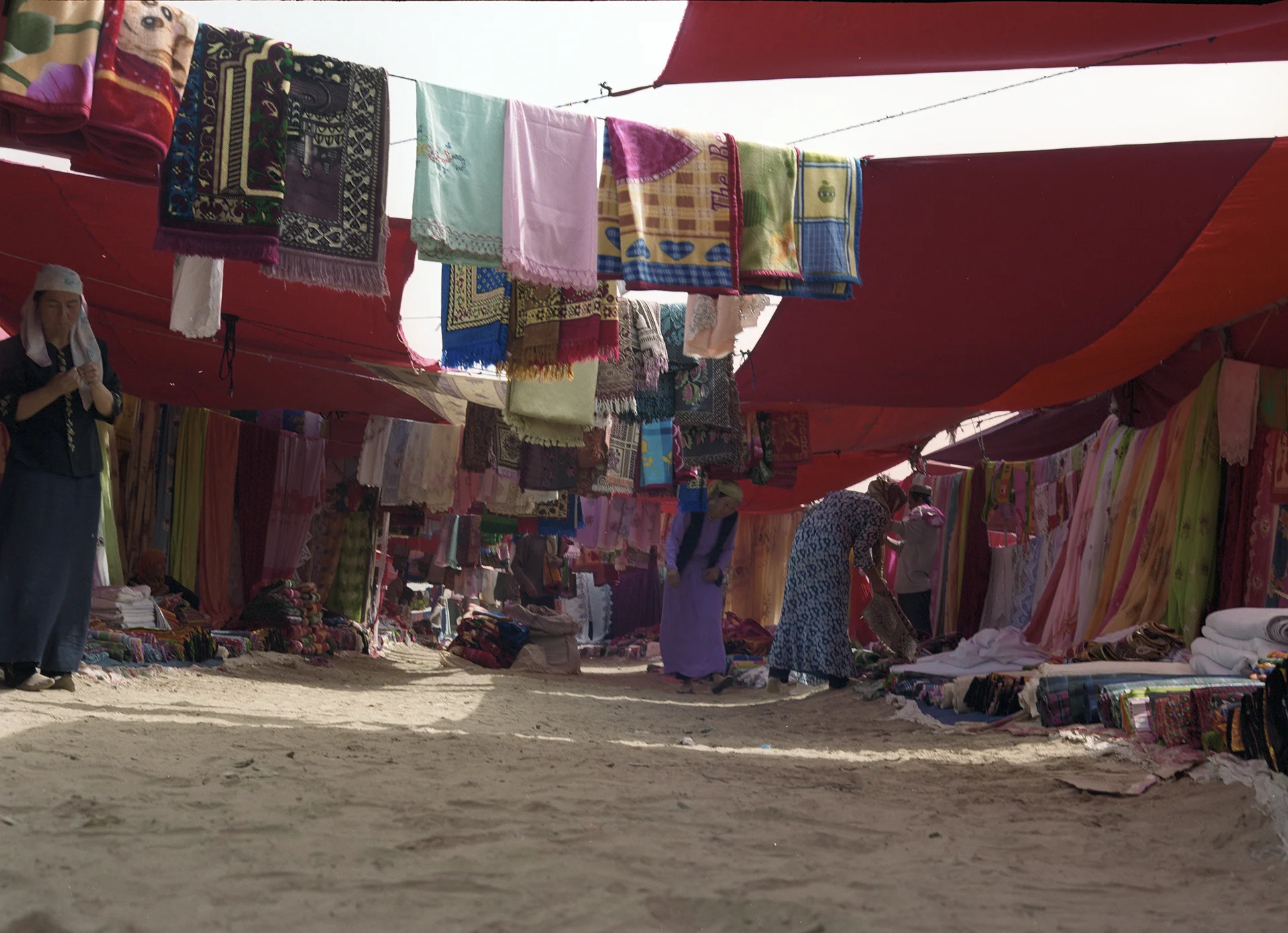 2007 Xinjiang - local market at Kuriyä. A full lane of women's delight.