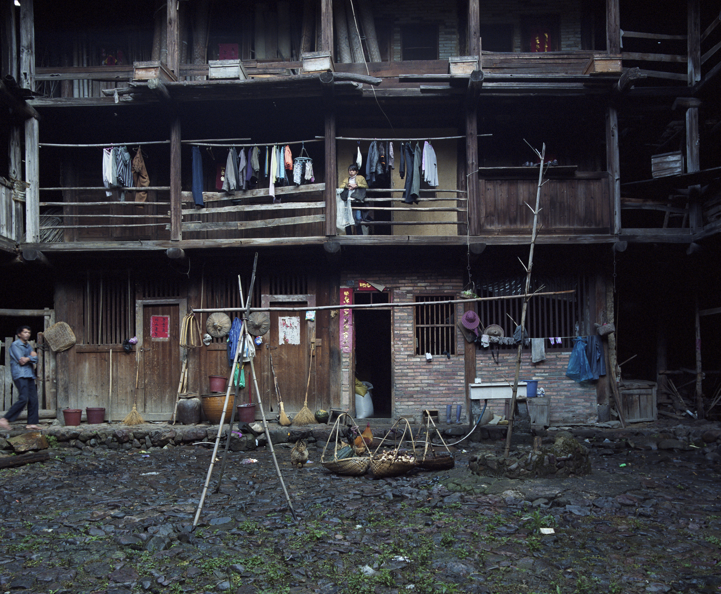 2009 Fujian - front of a Hakka house. On court level the living spaces, sleeping spaces higher up, storage above.