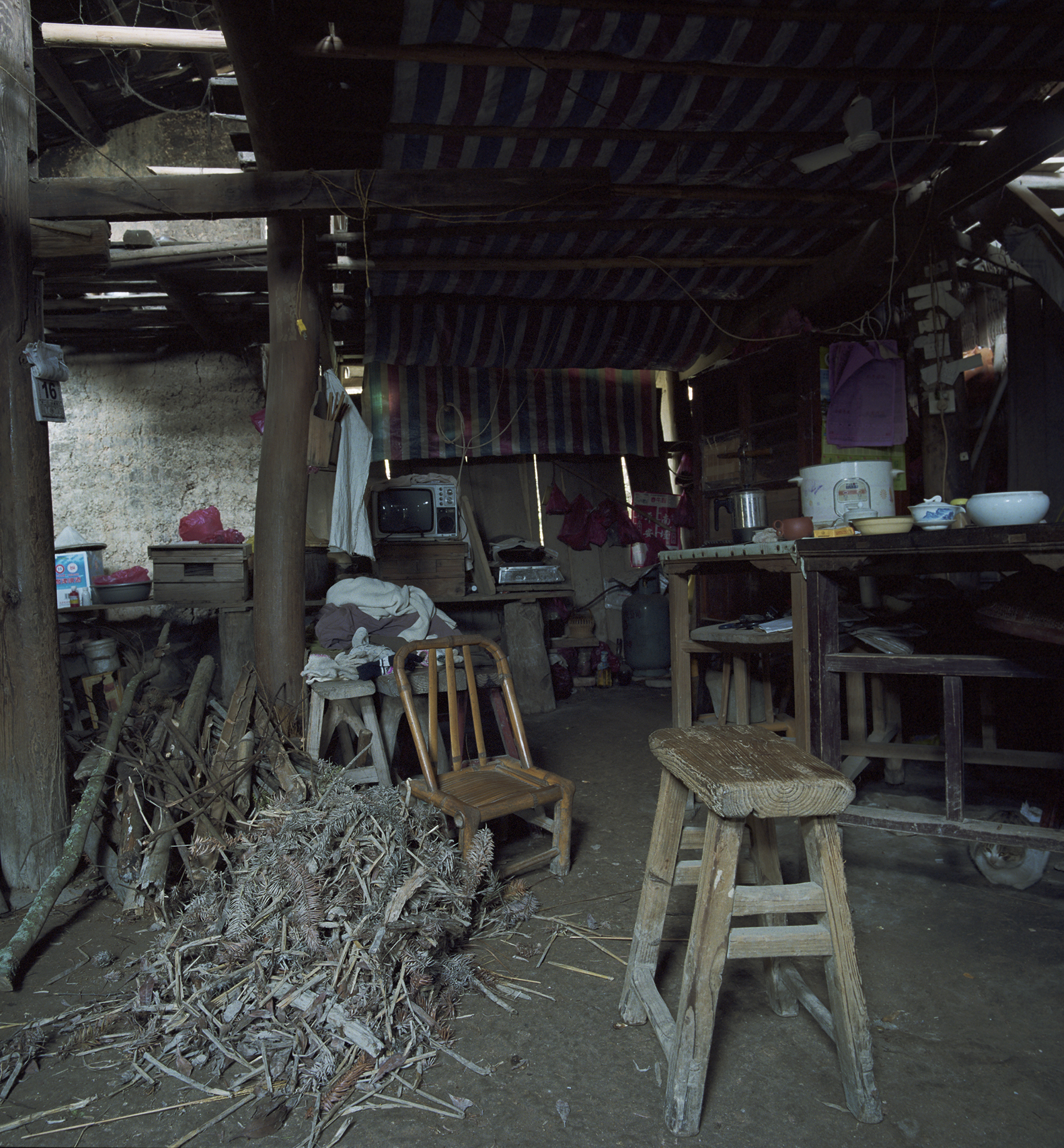 2009 Fujian - enough firewood to heat the stove in this very airy home.
