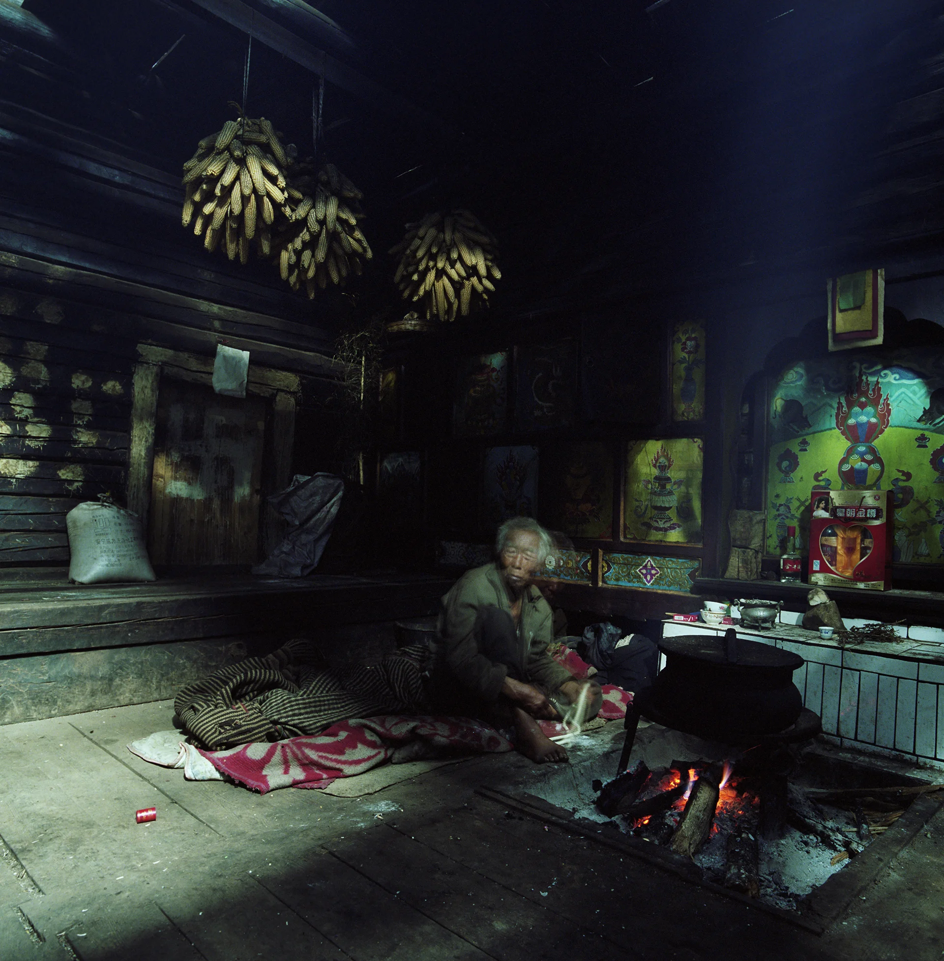 2010, in the vicinity of Lugu Lake - a Moso home. The brother in the house of his sister.