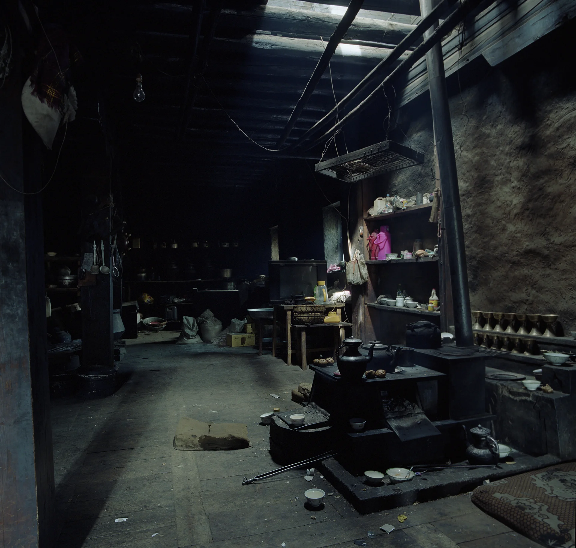 2010, Yading National Park - no windows in the house. Light is coming in through the hole in the ceiling.
