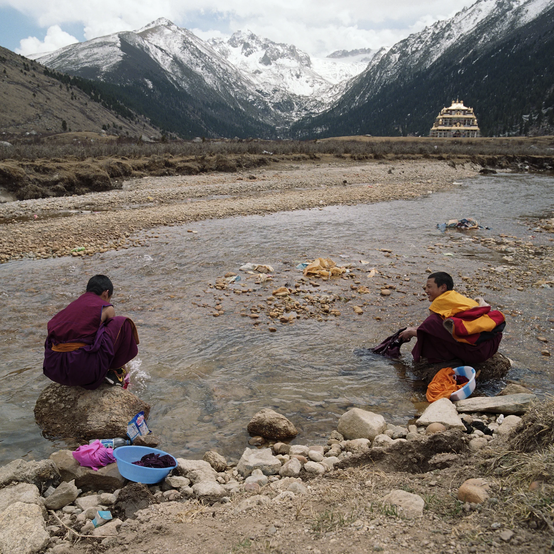 2010, near Maniggango - monks washing their cloth in very cold water.