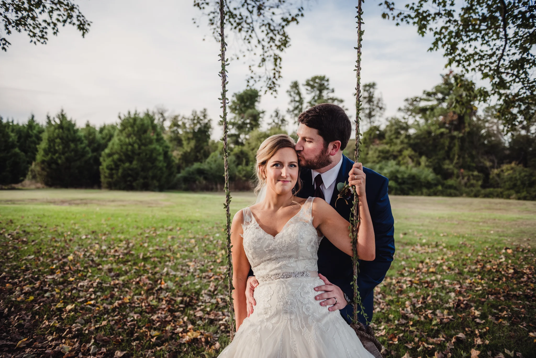 groom-kissing-bride-on-a-swing.jpg