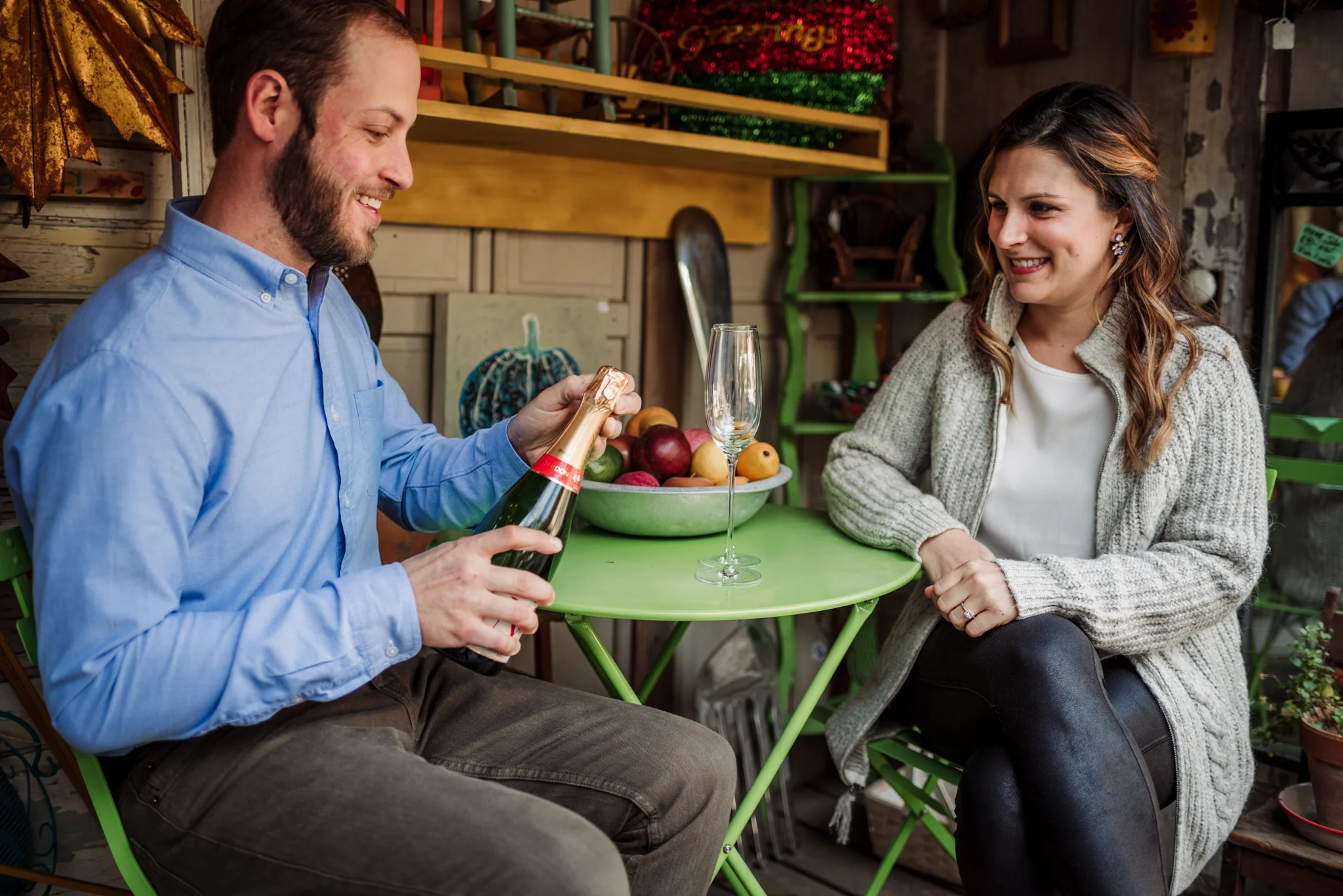 Opening-the-champagne-to-celebrate-their-engagement-in-Raleigh.jpg