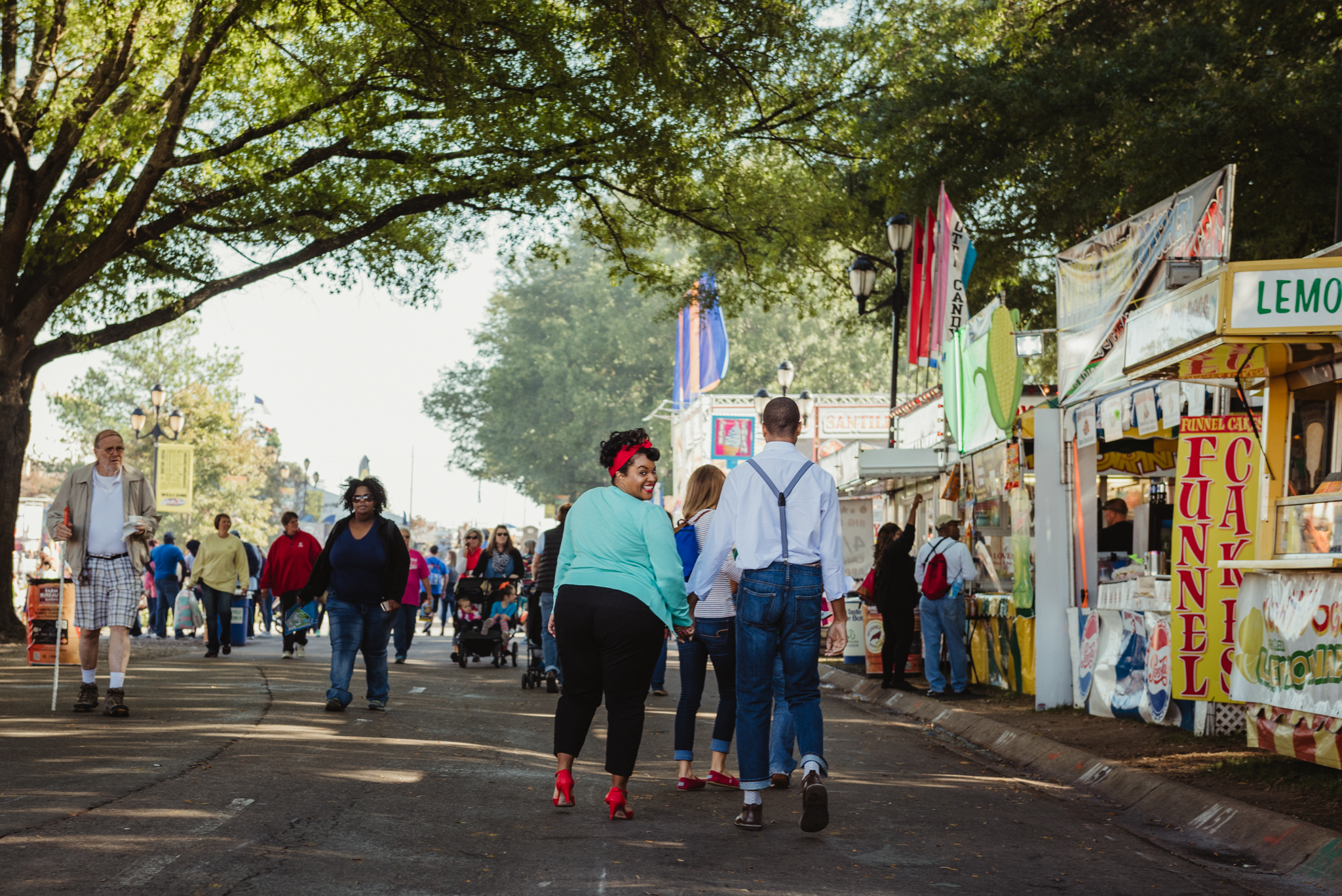 walking-the-midway-during-their-anniversary-session-at-the-NC-State-fair.jpg