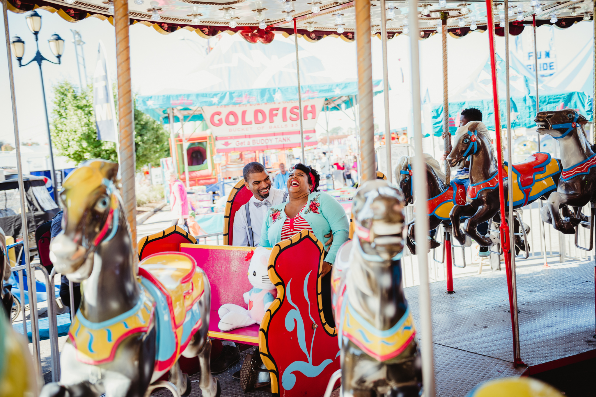 having-a-blast-during-our-photo-session-while-riding-the-carousel-at-the-NC-State-fair.jpg